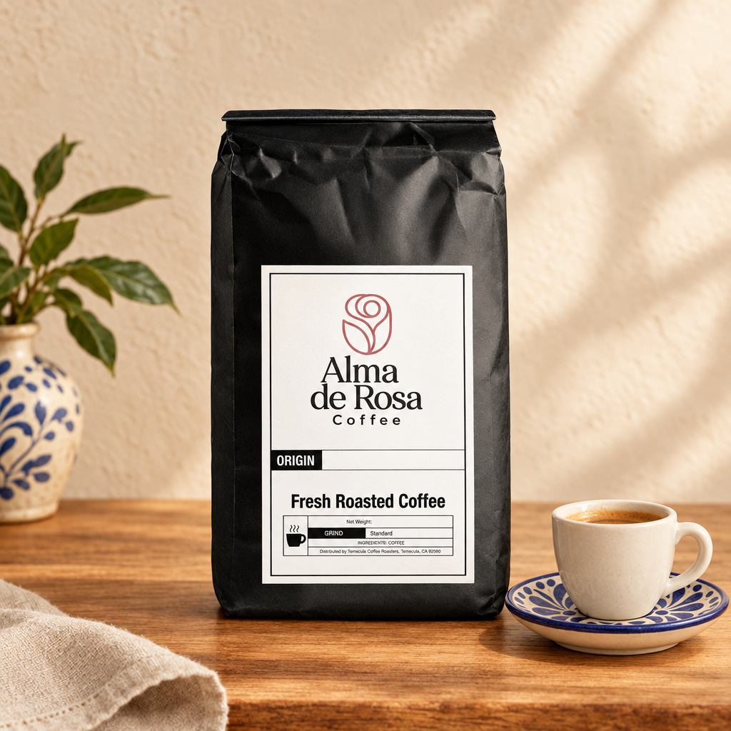 Alma de Rosa Mexico Coffee Pods bag with an espresso cup and Talavera-style saucer on natural oak