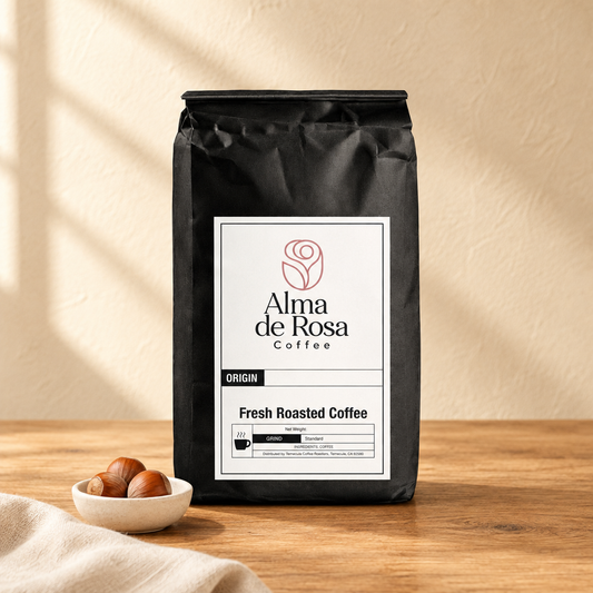 Alma de Rosa Hazelnut coffee bag on natural oak with cream background and hazelnut accents
