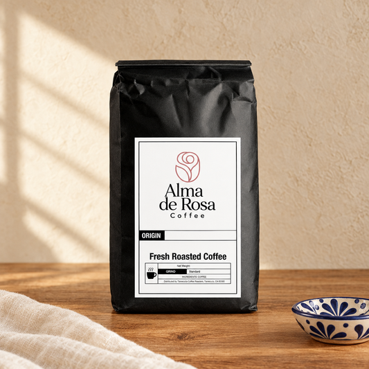 Alma de Rosa Mexico coffee bag on natural oak with cream background and artisan ceramic accents