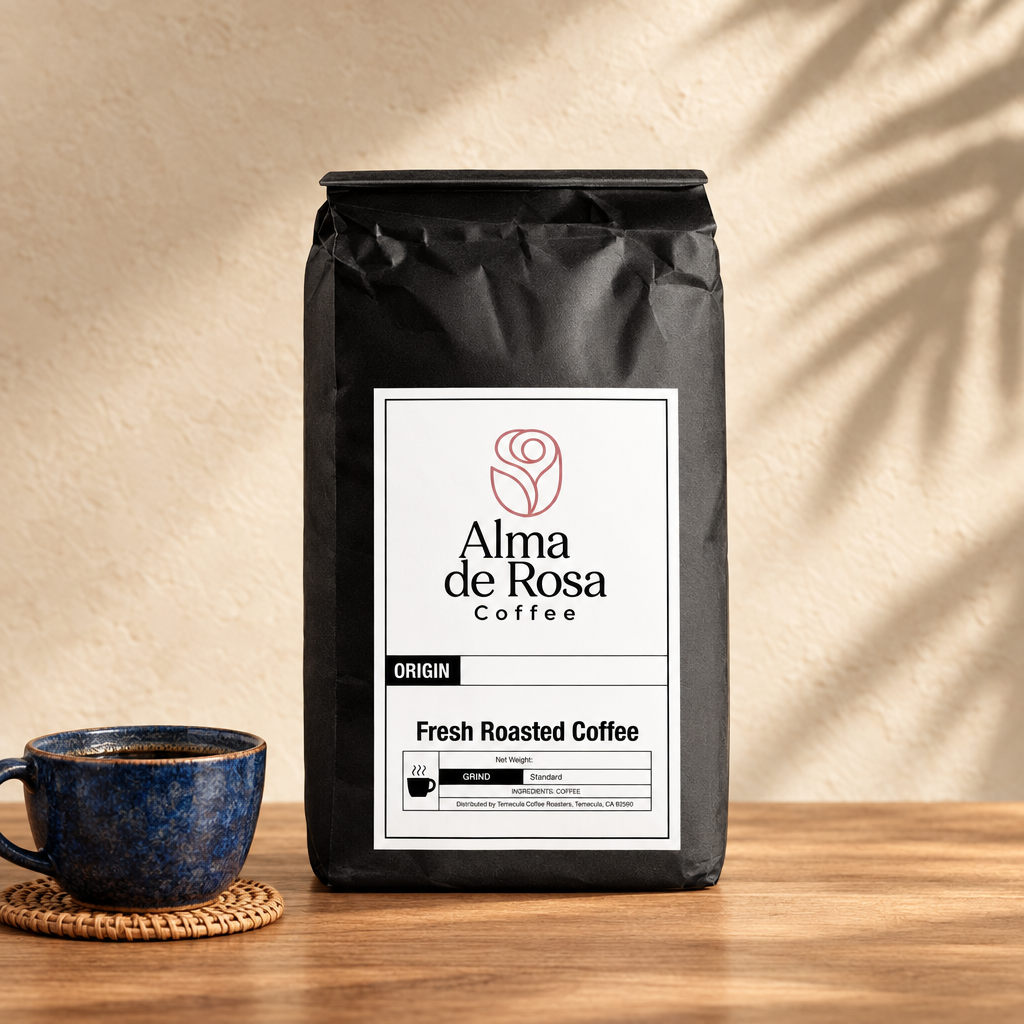 Alma de Rosa Bali Blue coffee bag with an indigo ceramic cup and woven coaster on natural oak